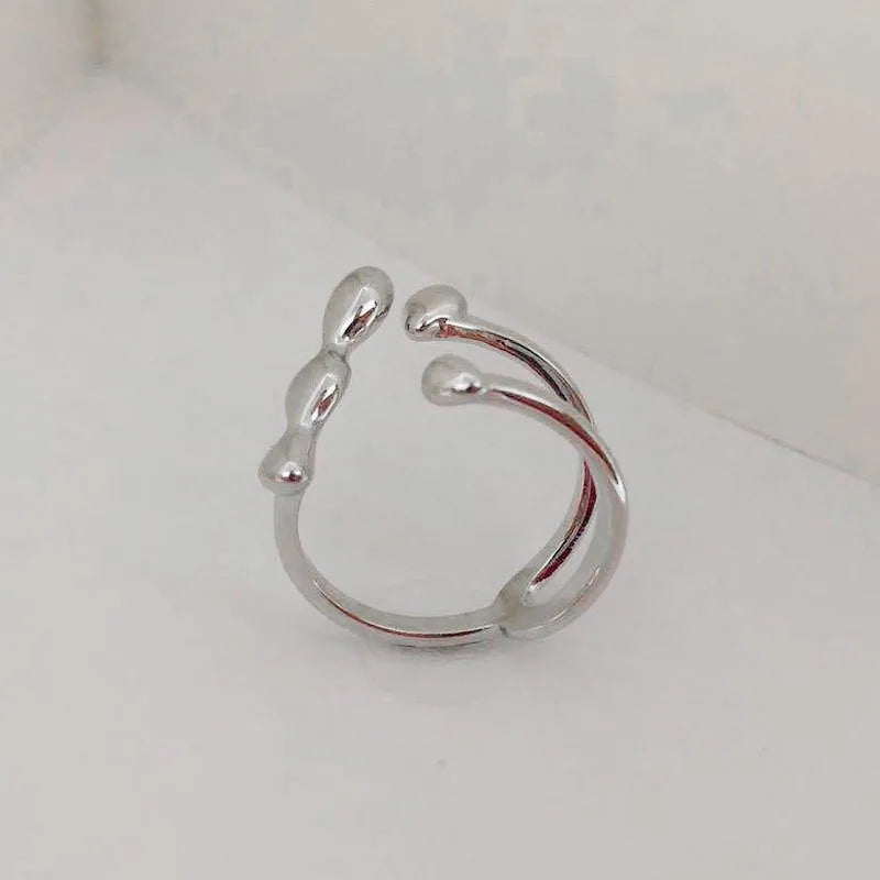 Adjustable brass opening ring with spherical design in gold or silver colour