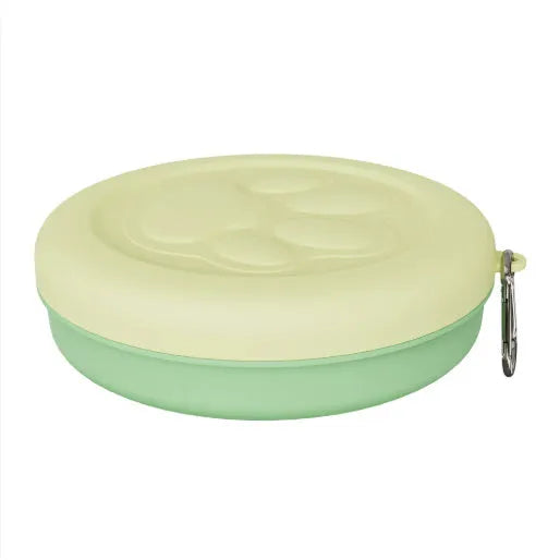 Collapsible silicone dog bowl in light pink and green colours showing portable feeding design