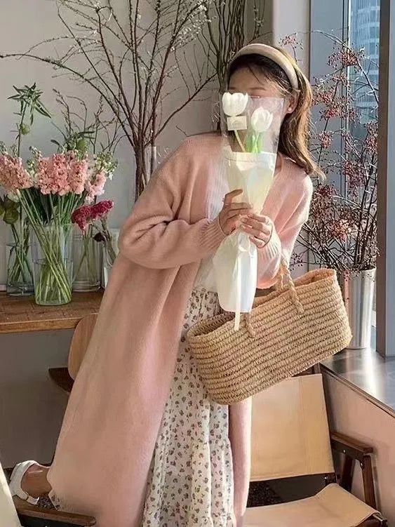 Women's knitted V-neck cardigan in loose fit showing mid-length silhouette and long sleeves