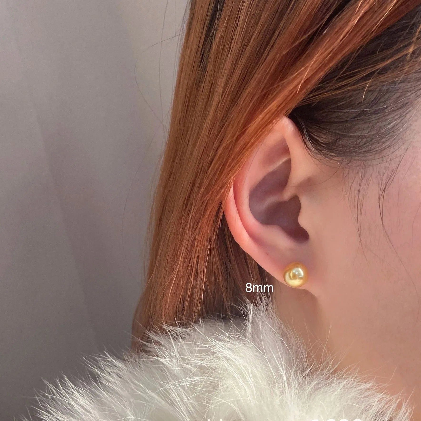 A pair of large geometric pearl stud earrings with a retro eight awn star motif on a silver setting.