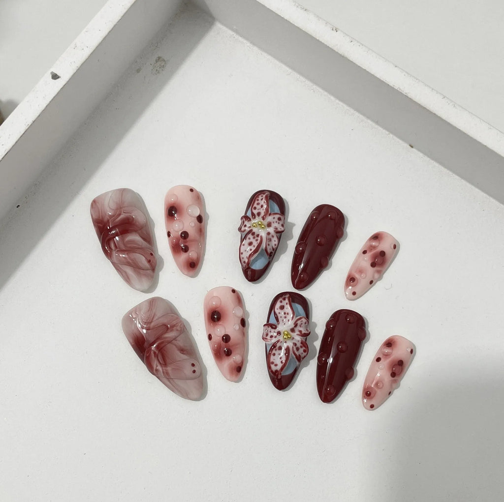 Hand-painted 3D carved artificial nails with floral designs on almond-shaped tips