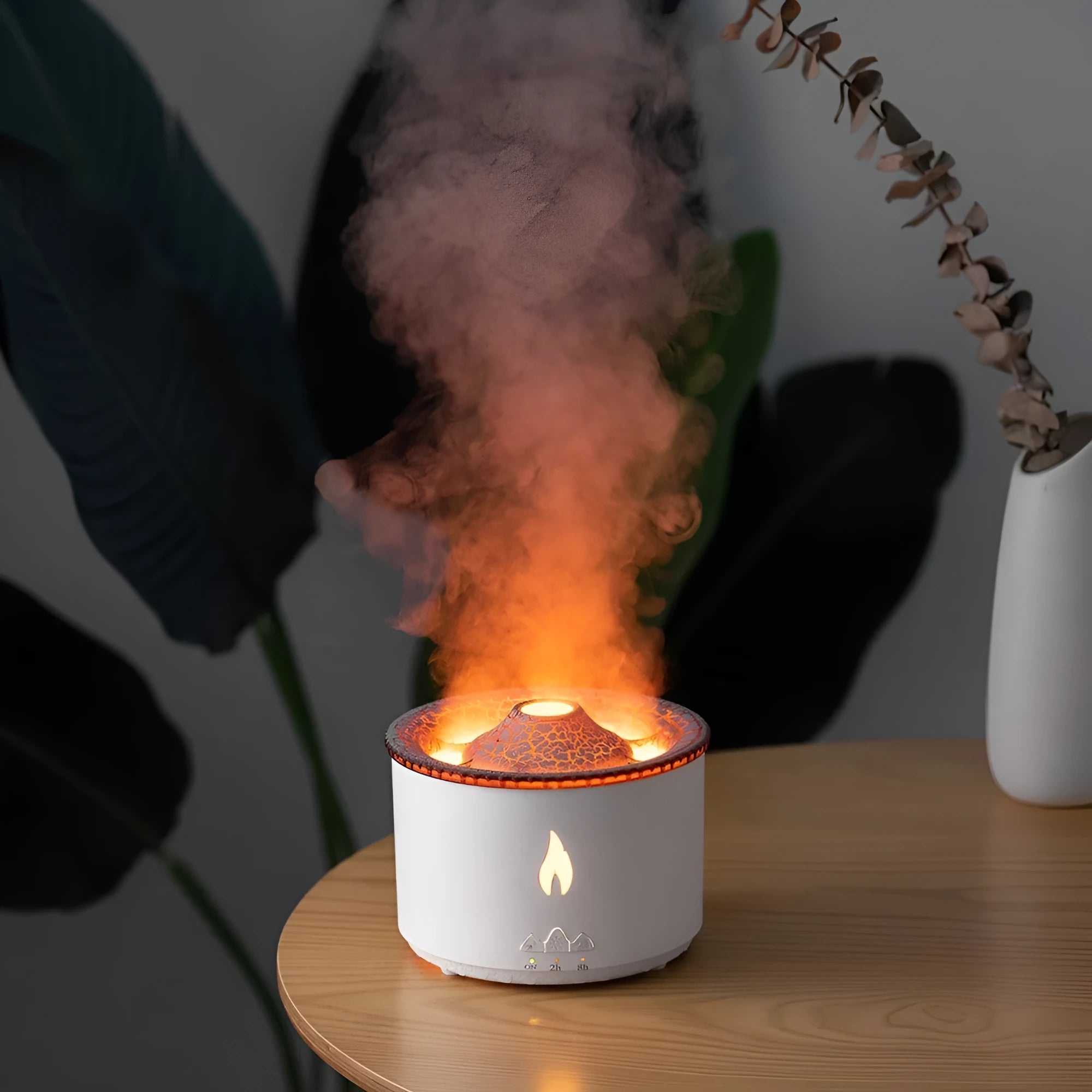 White volcano-shaped humidifier emitting a two-colour mist spray ring.