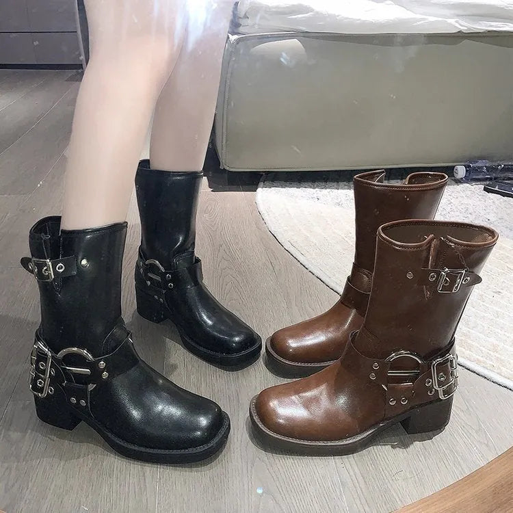 Black women's platform boots with a silver metal buckle strap on the ankle.