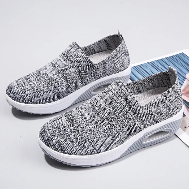 Women's casual running shoes with mesh and PU upper in light gray, showing round toe and mid heel.