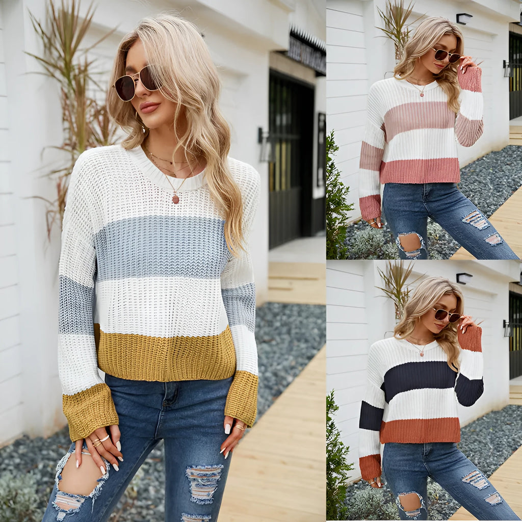 Short, loose-fitting striped women's pullover sweater on a hanger.
