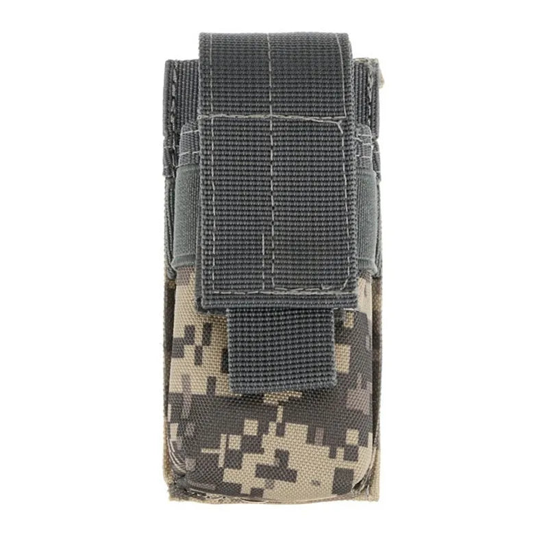 Black tactical MOLLE waist bag with elastic cord buckle, shown next to a small flashlight