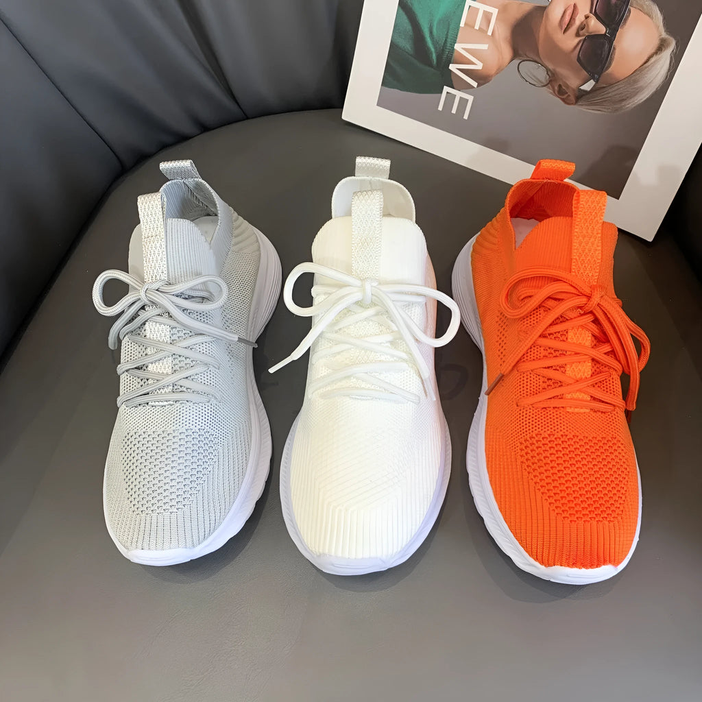 Women's mesh running shoes in creamy white with Flyknit upper and flat rubber sole