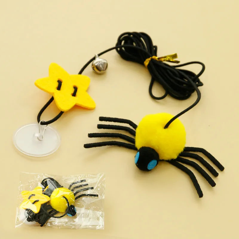 Cat door hanging toy with elastic rope, feather, bell, and spider design in red colour