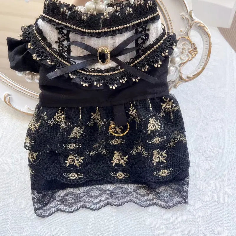 Golden gothic princess style polyester dress for a small dog on a mannequin, showing black skirt detail.