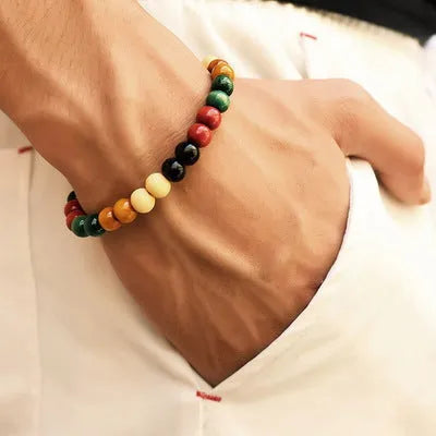Unisex ethnic-style beaded bracelet with lava stone on a wrist, showing essential oil application.