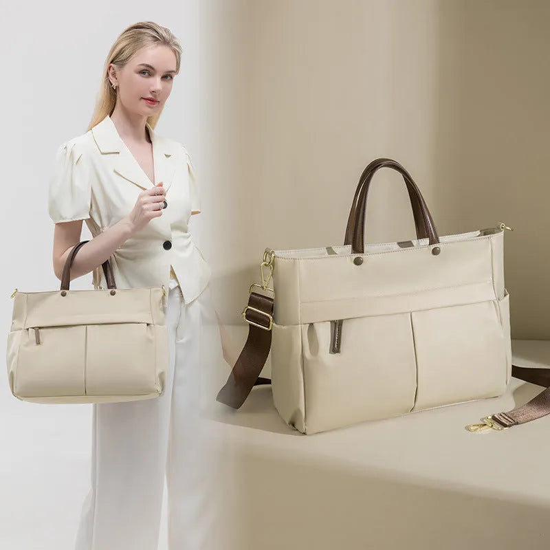 Portable oxford cloth laptop briefcase for women in elegant black with contrast stitching and large capacity.