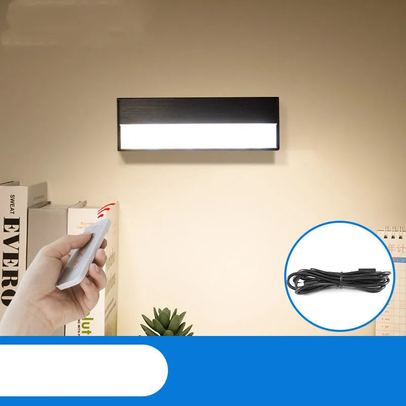 Compact white magnetic table lamp with a large luminous surface and USB charging port.