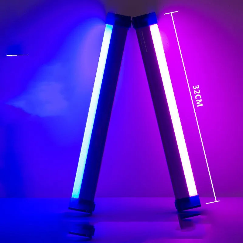 Blue and purple rechargeable LED tube light with USB cable on a dark background.