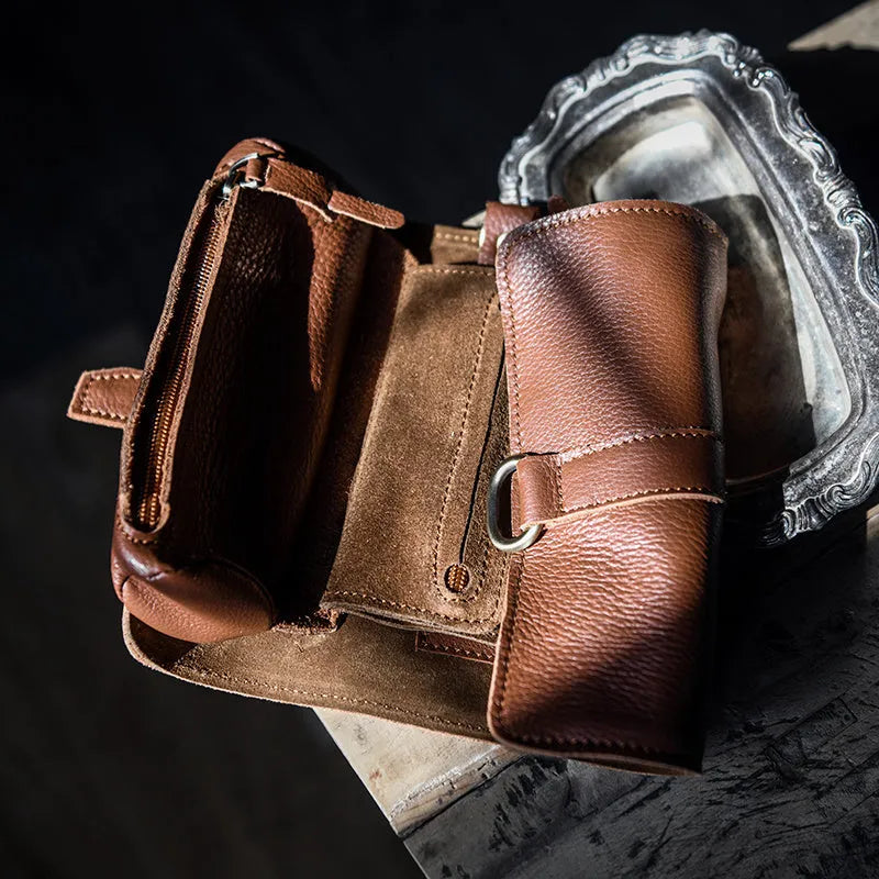 Handmade cow leather vintage wallet in black, showing tape extraction closure, 20cm long.