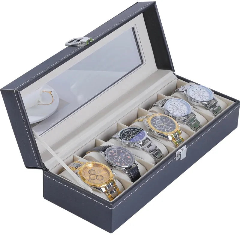 Grey leather watch storage box with transparent lid showing multiple watch slots inside