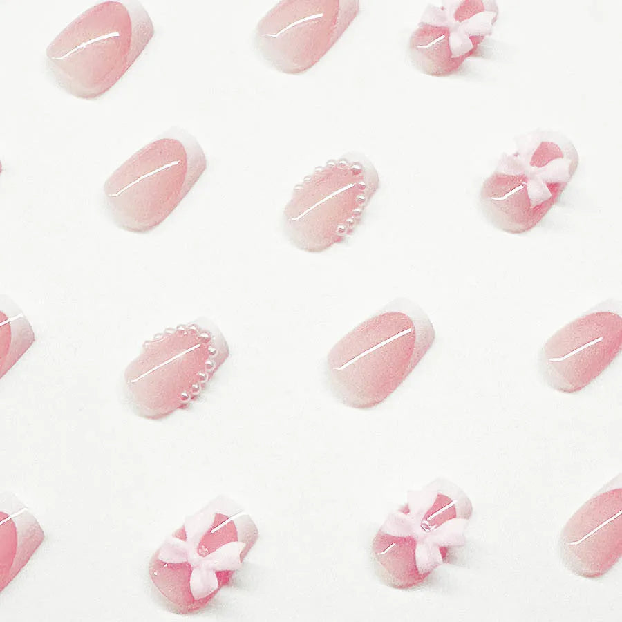 Short white French fake nails with cute bow and tulip patterns for ladies manicure
