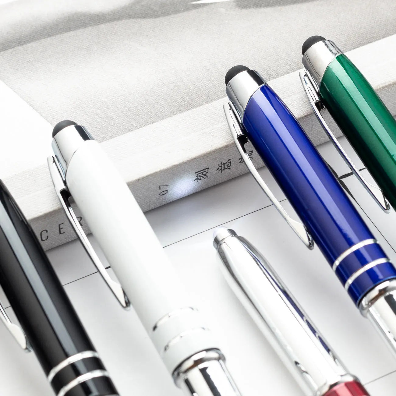 Red metal multifunctional pen with capacitive stylus tip, ballpoint, and LED light