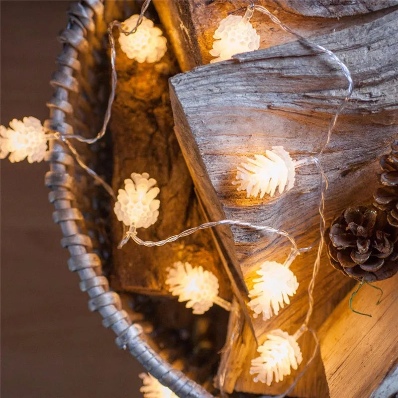 Warm white LED pine cone fairy lights on a string, powered by batteries for cord-free decoration.