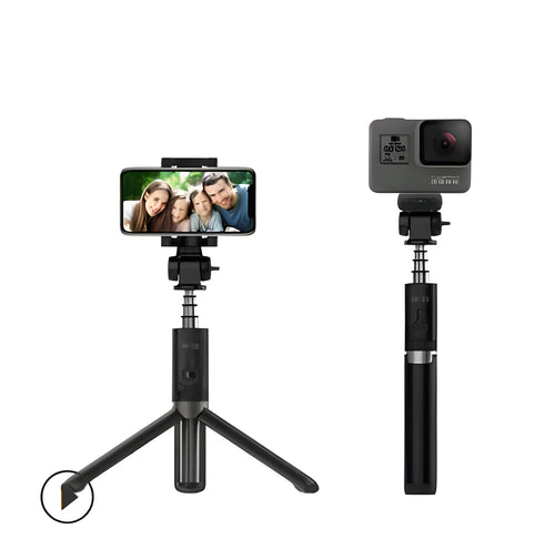 Black Bluetooth selfie stick tripod with remote control extended next to mobile phone