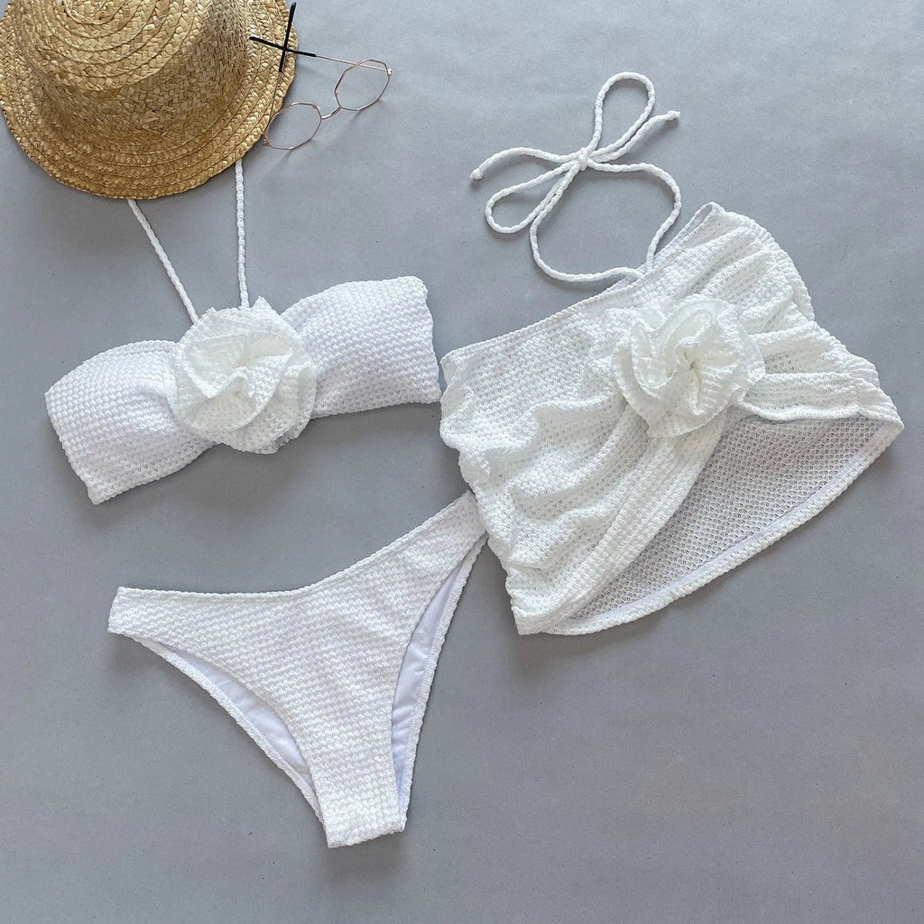 Women's white 3D flower split bikini set with bra, skirt, and briefs.