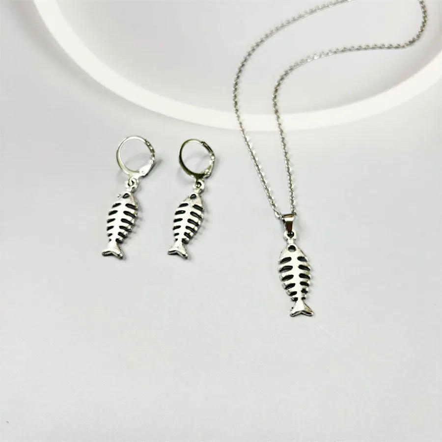 Women's fishbone pendant alloy necklace and matching earrings set on a white background