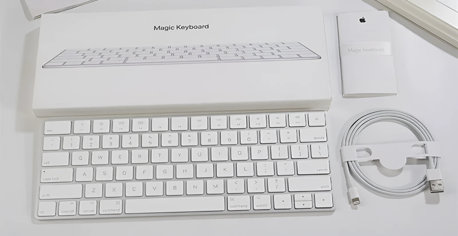 White Apple ultra-thin metal Bluetooth G6 wireless keyboard on a desk.