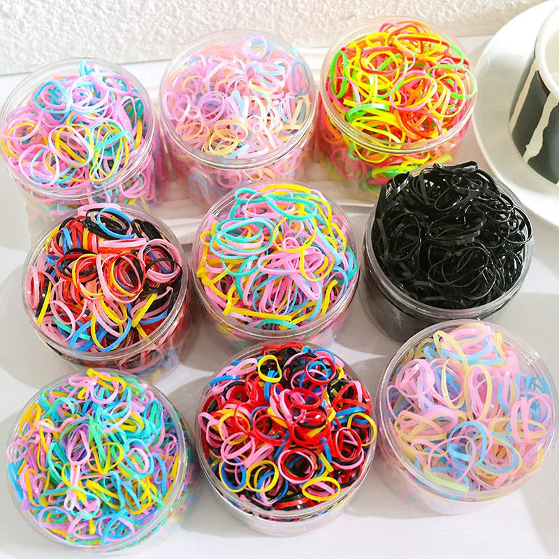 Pack of multicoloured thin TPU baby hair ties stored in a clear reusable plastic container.