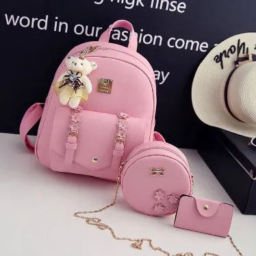Three-piece women's bag set showing backpack, shoulder bag, and card wallet in matching colour