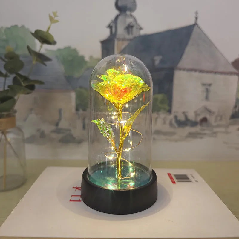 Small plastic night lamp with floral decoration and coloured light options on a black base.