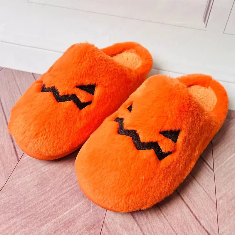 Orange Halloween pumpkin slippers with plush construction and non-slip soles in paired adult sizes