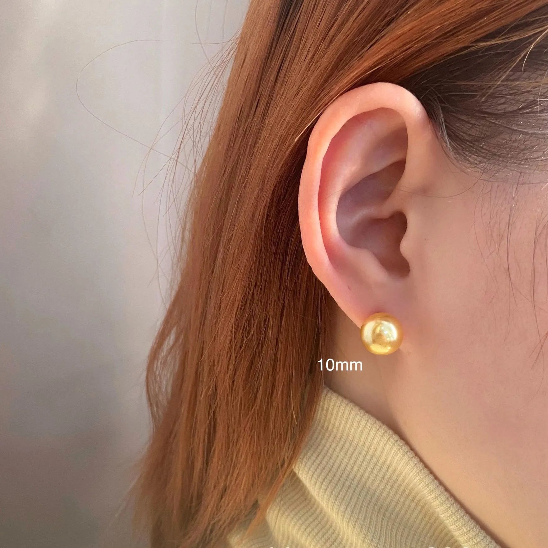 A pair of large geometric pearl stud earrings with a retro eight awn star motif on a silver setting.