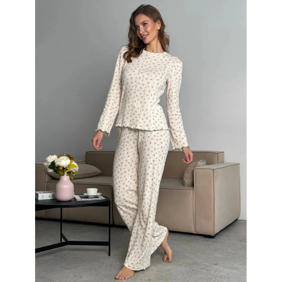 White floral print women's loungewear suit with bell sleeve top and wide-leg trousers.