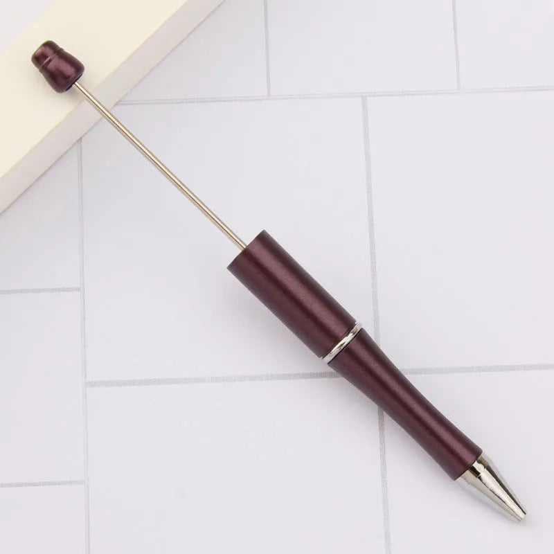Creative ballpoint pen with multicoloured spinning plastic beads on a steel wire frame.