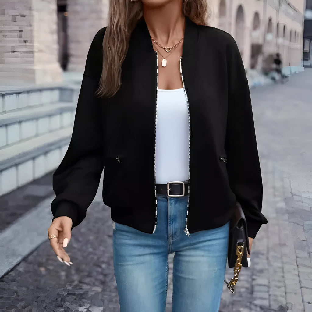 Black women's zip jacket with faux pockets and long sleeves on hanger