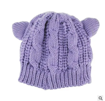 Hand-made chunky wool beanie with 3D knitted cat ears on a white background.