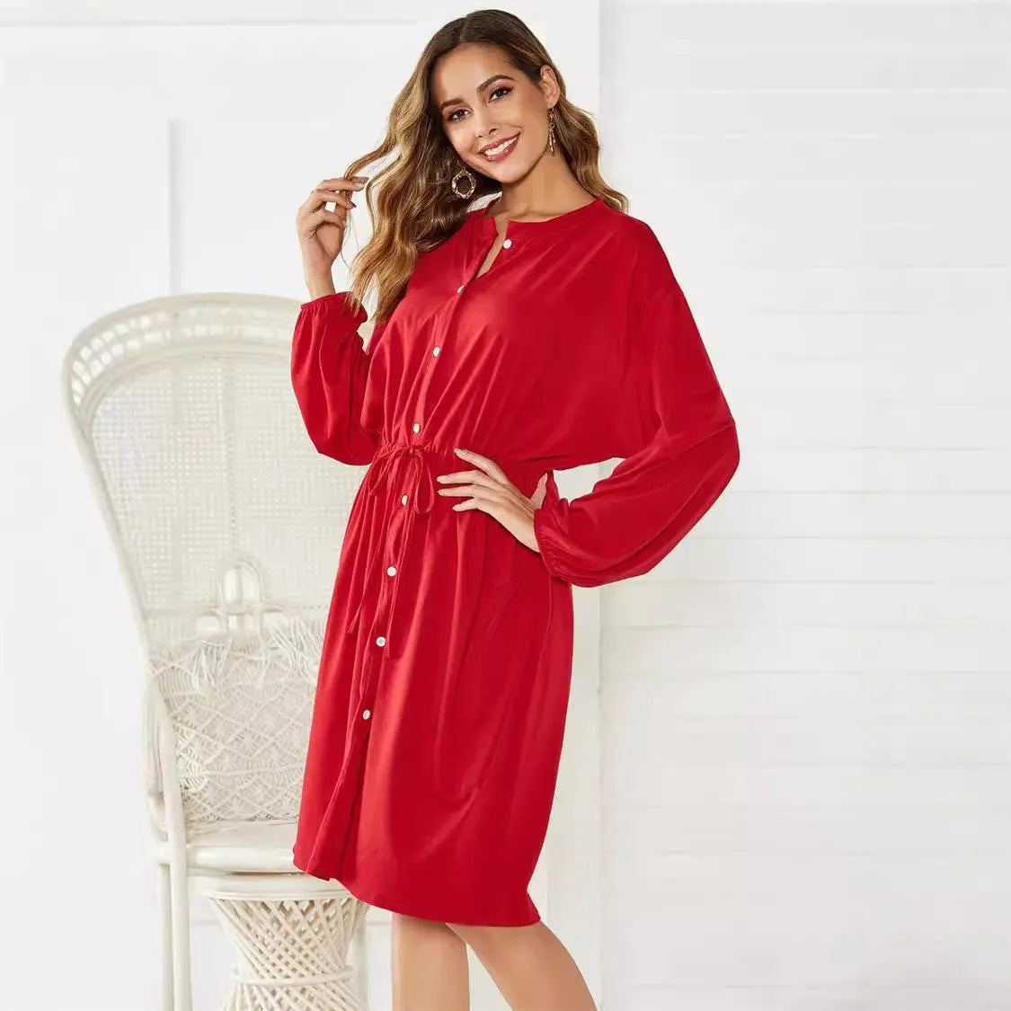 Women's black elastic waist A-line dress with cinched belt and long sleeves
