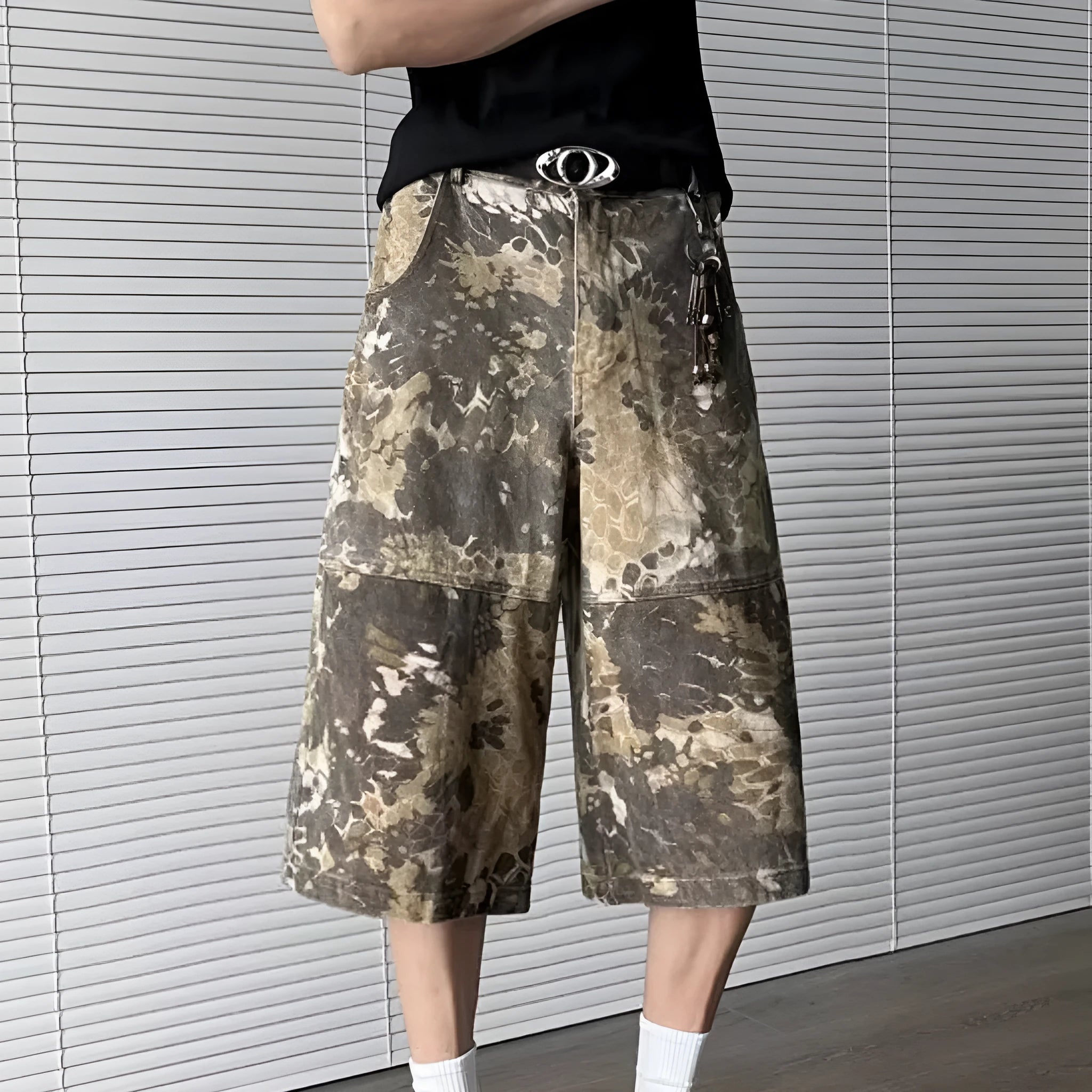 Yellow women's cropped jeans with a large snake camouflage pattern tooling print on the denim fabric.