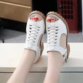 Women's retro sandals with side zip closure and a medium heel in creamy white.
