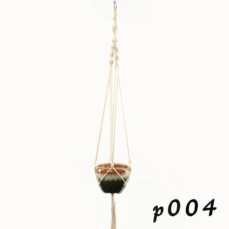 Woven cotton rope plant holder in a desktop style with greenery inside.