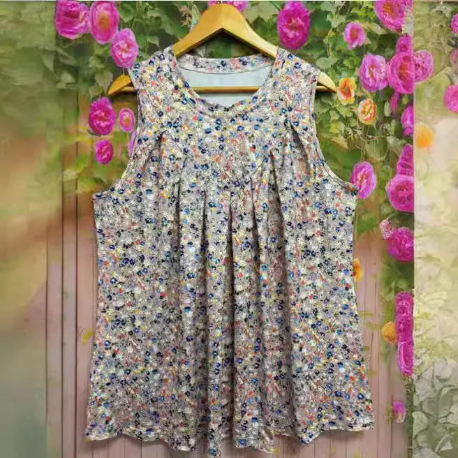 Black floral print plus size sleeveless vest on a hanger showing round neck and loose fit.