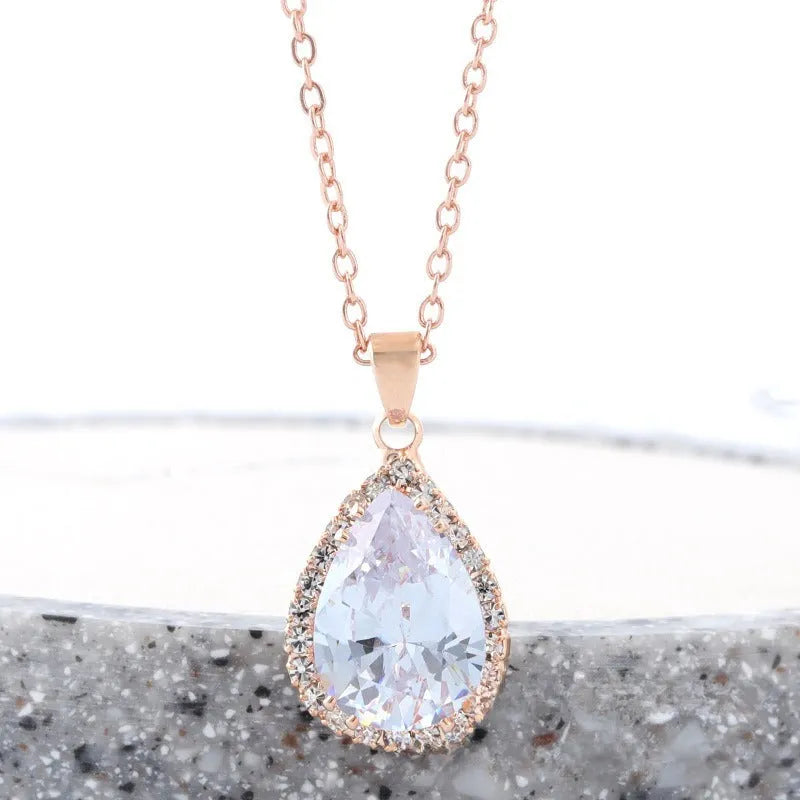 Pink water drop geometric necklace with rose gold electroplating and rhinestone detailing on alloy pendant
