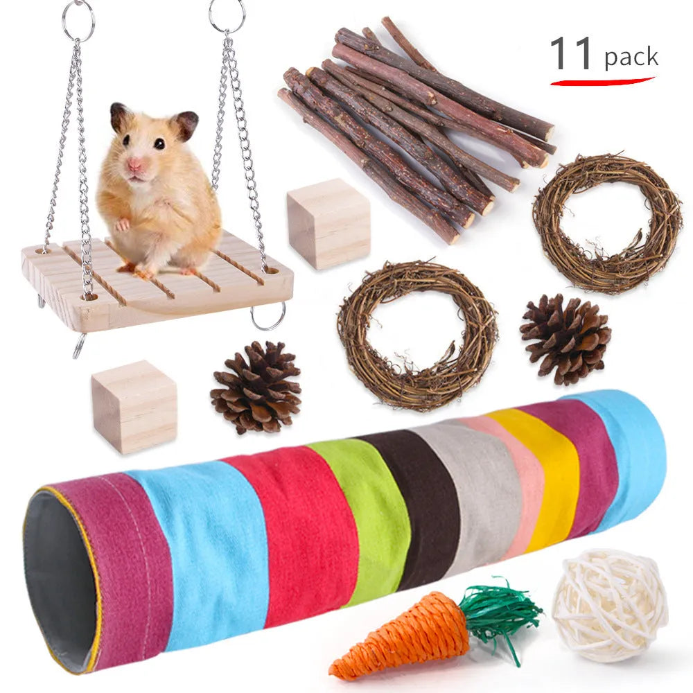 Assortment of wooden and natural fibre chewing toys for pet rabbits, guinea pigs, and parrots on a straw mat