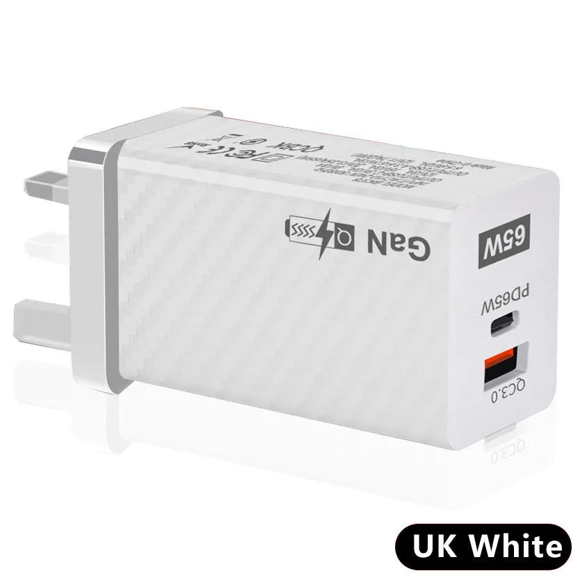 White 65W Gallium Nitride USB-C laptop charger with EU plug next to black version with US plug.