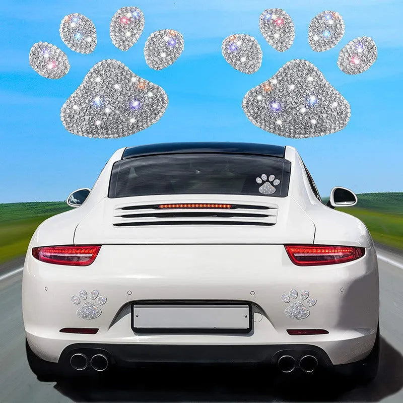 Close-up of a diamond-encrusted glass car sticker in a butterfly or bear claw design on a white background.