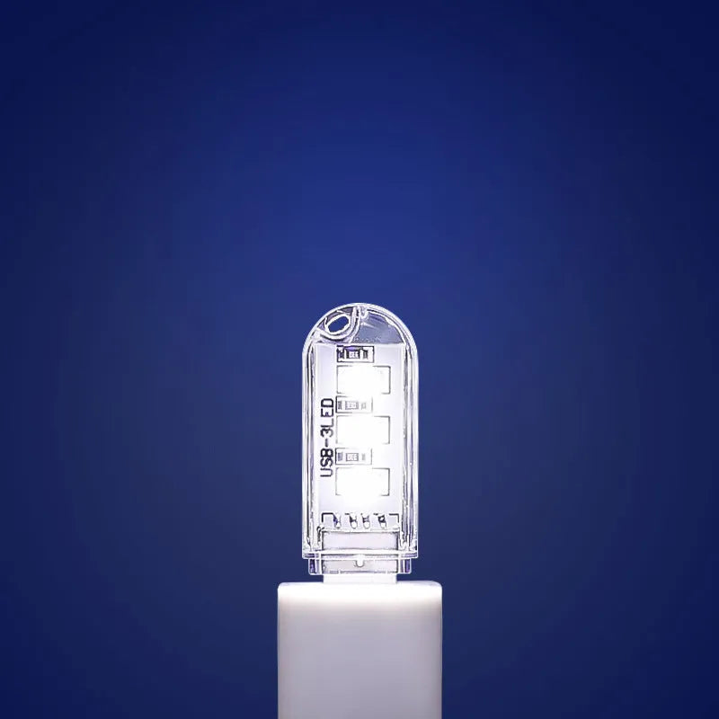 Small white USB-powered LED night light showing warm and cool white light options