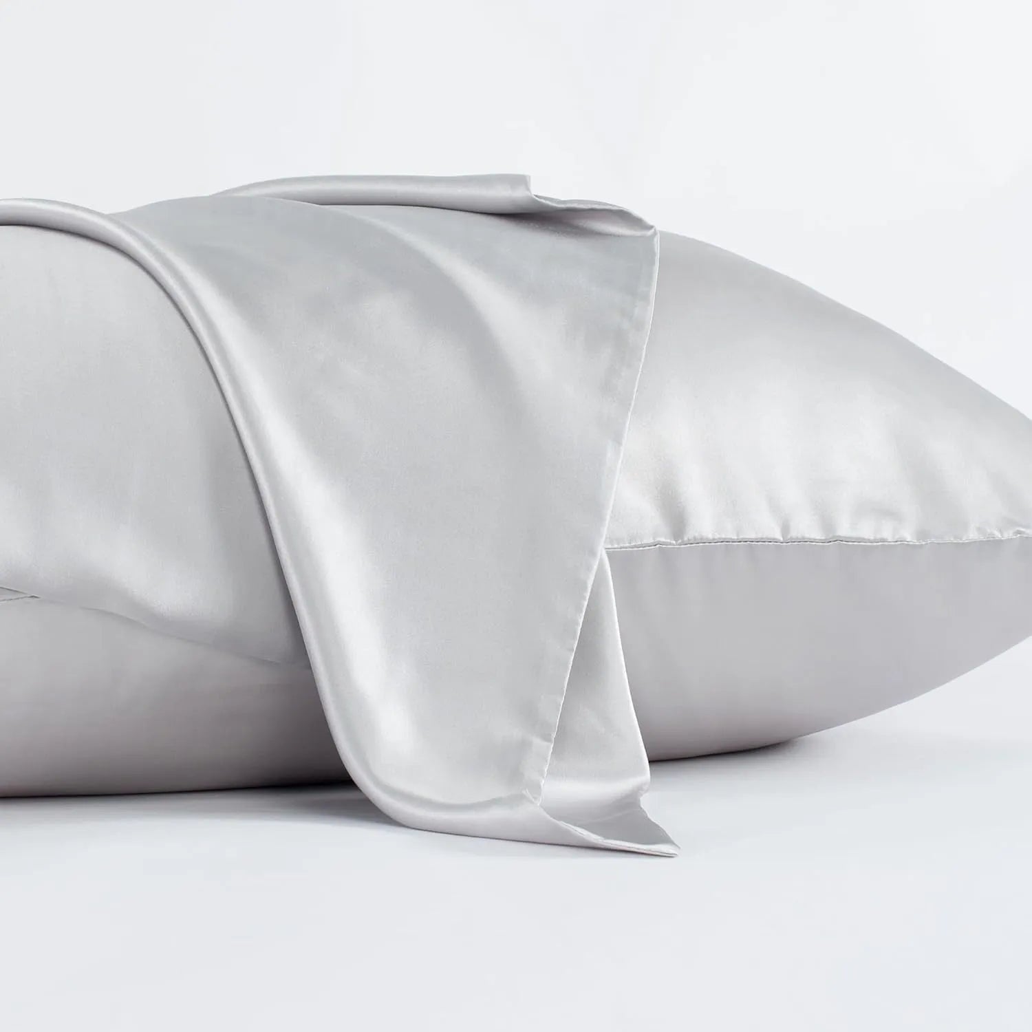 Dark grey silk pillowcase with envelope closure, shown flat and on a pillow.