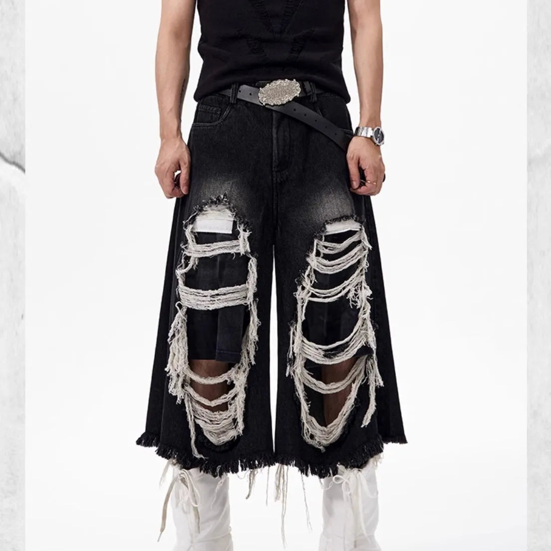 Black women's cropped wide leg jeans with a distressed patch detail on the leg.