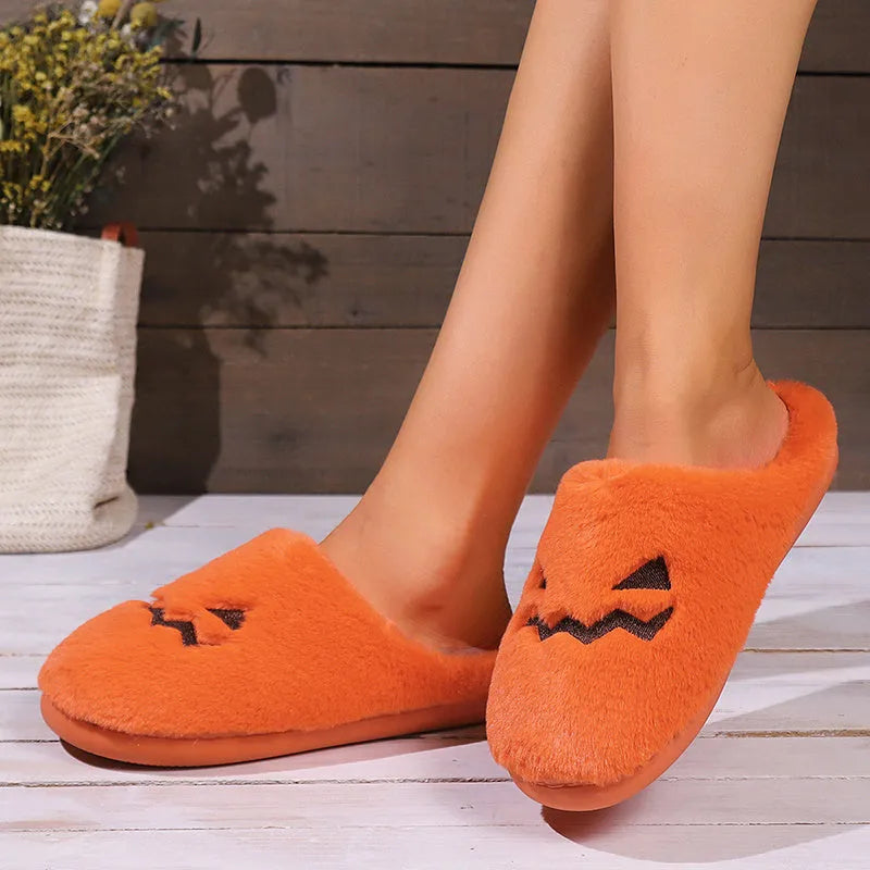 Orange Halloween pumpkin slippers with plush construction and non-slip soles in paired adult sizes