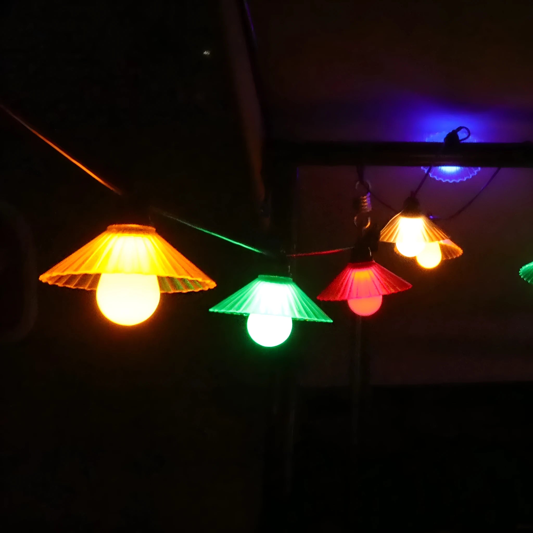 Outdoor LED string lights with flower-shaped bulbs in garden setting showing IP65 waterproof rating