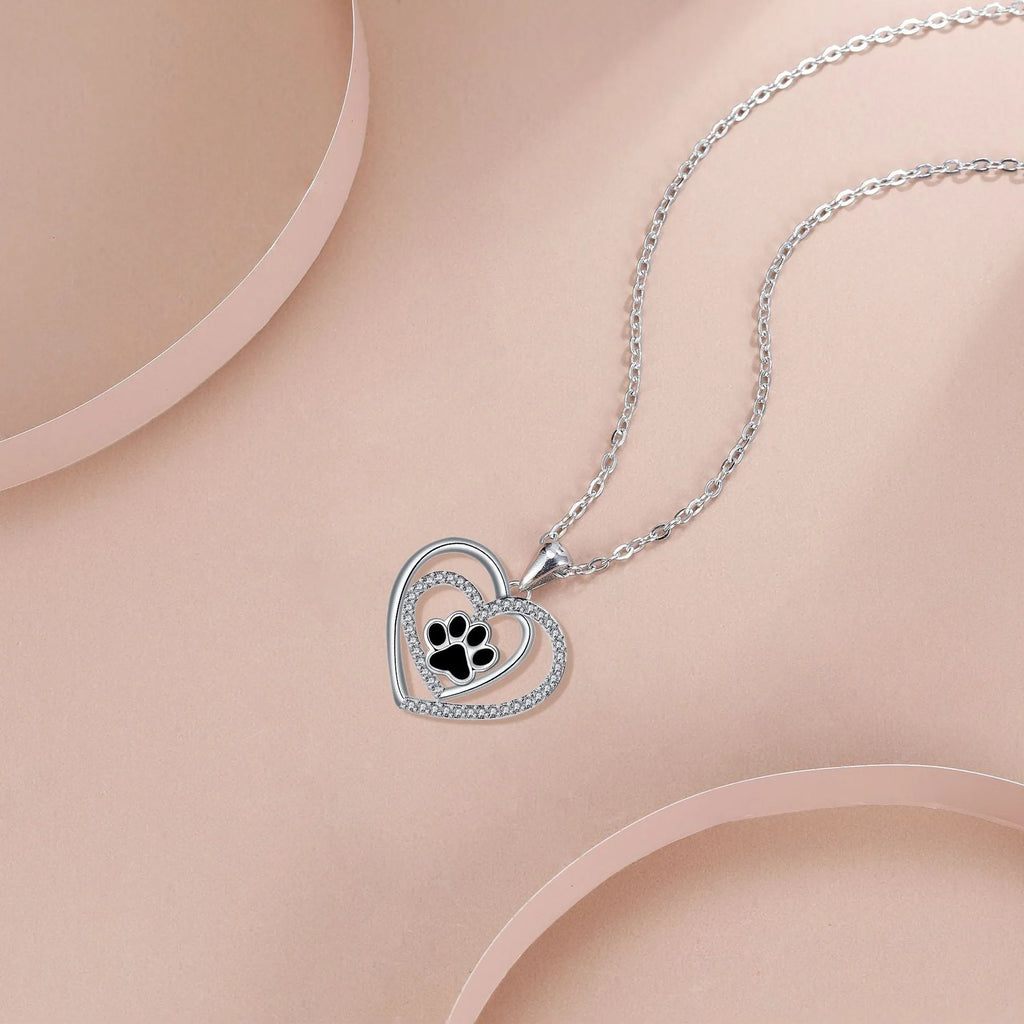 Women's copper necklace with dog's paw footprints and heart-shaped pendant on cross chain